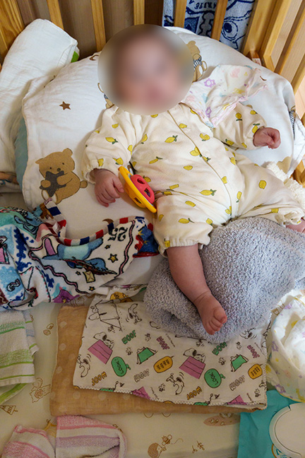 baby sleeping on nursing cushion